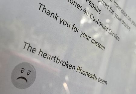 © Reuters. The detail of a printed message is seen on a branch of Phones 4u in west London