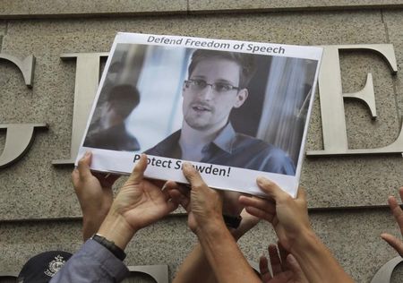 © Reuters. Protesters supporting Snowden hold a photo of him during a demonstration outside the U.S. Consulate in Hong Kong