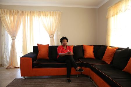 © Reuters. Modingoane, a 30-year-old miner and single mother, sits in a house, part of a 2.8 billion rand housing project put together by her employer at the WaterKlooff Hills in Rustenburg