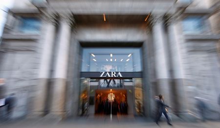 © Reuters. People walk past a Zara store in Barcelona