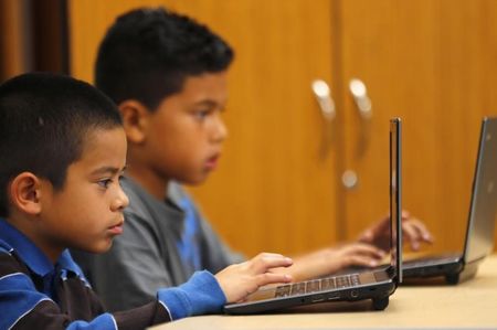 © Reuters. Grade four students work on laptop computers at Monarch School in San Diego, California