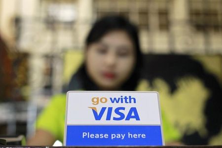 © Reuters. A Visa sign is seen on a cashier's desk at a restaurant in Yangon