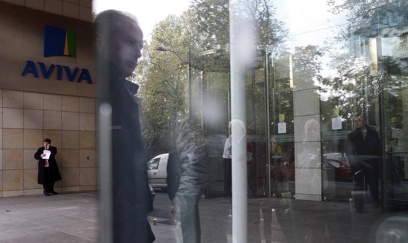 &copy; Reuters A man is reflected in a window near the entrance to the AVIVA headquarters building in Dublin.