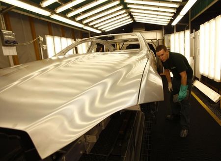 © Reuters. Staff work on the Jaguar XJ production line at their Castle Bromwich Assembly Plant in Birmingham