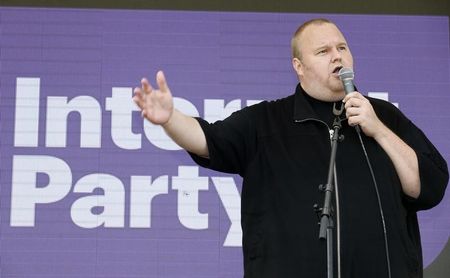 © Reuters. Kim Dotcom talks to supporters at his Internet Party pool party at the Dotcom mansion in Coatesville, Auckland