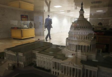 © Reuters. A staffer in the Dirksen Senate building walks past a scale model of the U.S. Capitol in Washington