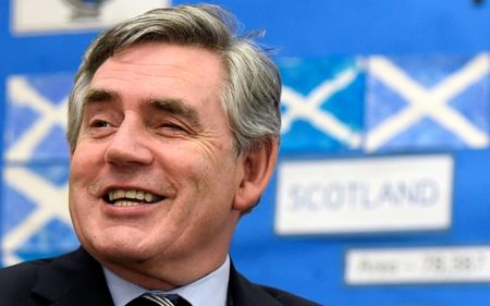 © Reuters.  Former British Prime Minister Gordon Brown speaks to pupils during a visit to Kelty Primary School in Fife