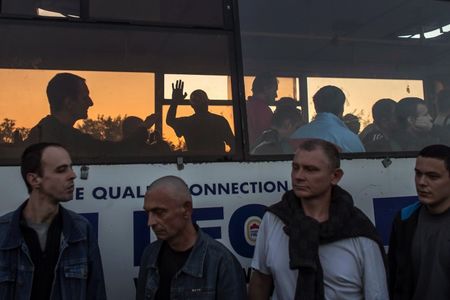 © Reuters. A member of the pro-Russian rebels, who is a prisoner-of-war (POWs), waves from inside a bus as he waits with others to be exchanged, north of Donetsk, eastern Ukraine