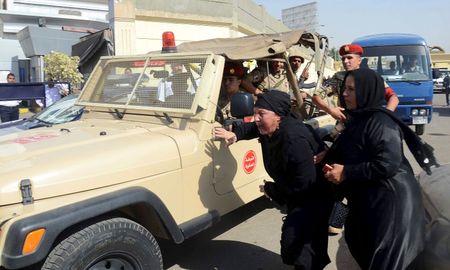 © Reuters. Family members of security forces killed in Sinai on Friday react near an army vehicle as they wait for the bodies of their relatives at Almaza military airbase in Cairo