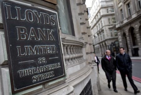 © Reuters. File photograph shows pedestrians walking past a branch of Lloyds Bank in the City London