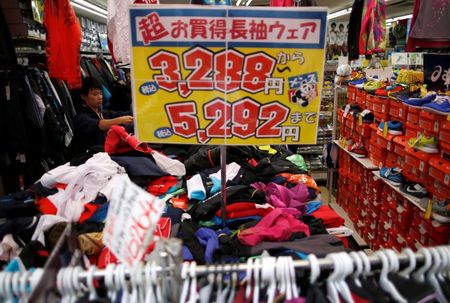 © Reuters. A shopper looks at sports wear in a sports clothing store at a shopping district in Tokyo