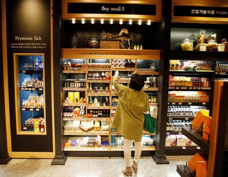 © Reuters. A woman shops at a store selling small-sized products at a department store in Seoul