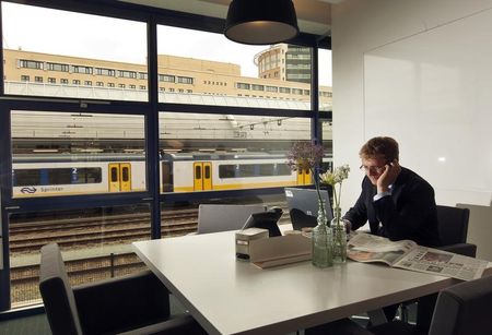 © Reuters. Man works in the brand new Regus workspace at the railway station in Amersfoort