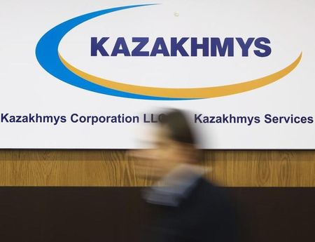 © Reuters. A man walks past the logo of mining group Kazakhmys, at the company's office in Almaty
