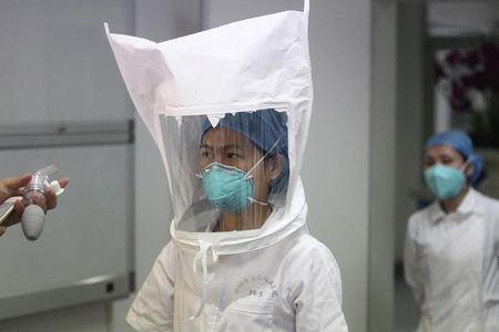 © Reuters. Membro de equipe médica prova um traje de proteção para Ebola em um hospital de Shenzen, na província de Guangdong, China 