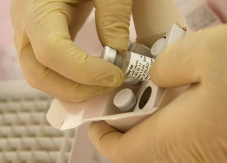 © Reuters. Scientists at the National Microbiology Lab in Winnipeg prepare an experimental Ebola vaccine for shipment to the World Health Organization