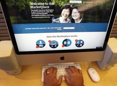 © Reuters. A man looks over the Affordable Care Act signup page on the HealthCare.gov website in New York in this photo illustration