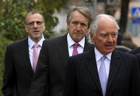 © Reuters. Xstrata Chairman Bond, CFO Reid and CEO Davis arrive before an extraordinary shareholder meeting in Zug