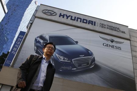 © Reuters. A man walks past a Hyundai dealership in Seoul