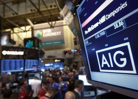 © Reuters. The American International Group, Inc. (AIG) stock ticker is seen on a monitor as traders work on the floor of the New York Stock Exchange