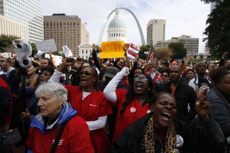 © Reuters. File photo of protesters marching with their hands raised at a rally in St. Louis