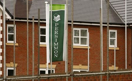 © Reuters. A Persimmon banner flies at a housing development near Manchester