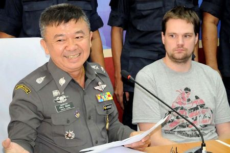 © Reuters. Pirate Bay co-founder Neij is surrounded by policemen at the immigration office in Nong Khai province