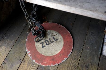 © Reuters. A Zoll (Customs) sign is seen on a wooden bridge over the Rhein river between Switzerland and Germany in Rheinau