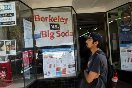 © Reuters. A man walks past the Measure D election headquarters in Berkeley