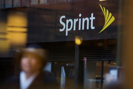© Reuters. File photo of people walking past a Sprint store in New York