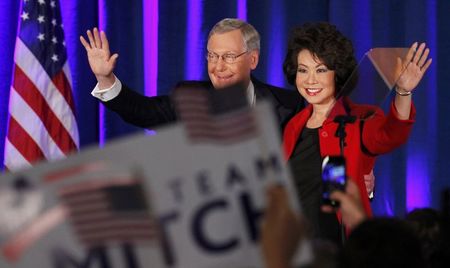 © Reuters. U.S. Senate Minority Leader Mitch McConnell waves to supporters with his wife Elaine Chao at his midterm election night rally in Louisville