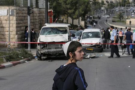 © Reuters. An Israeli boy stands at the scene of an attack in Jerusalem