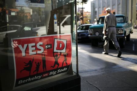 © Reuters. A sign for the "Yes on D" campaign in the window of the Measure D election headquarters in Berkeley