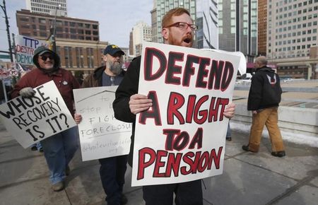 © Reuters. Activists rally for jobs and pensions outside Cobo Center before auto show in Detroit