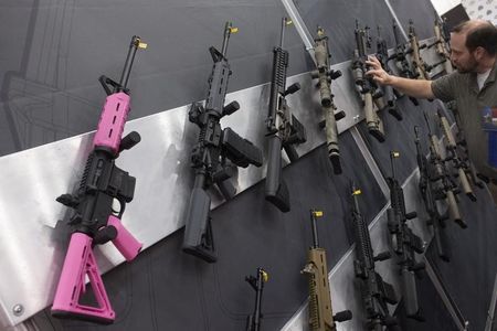 © Reuters. A pink assault rifle hangs among others at an exhibit booth at the George R. Brown convention center, the site for the National Rifle Association's (NRA) annual meeting in Houston, Texas