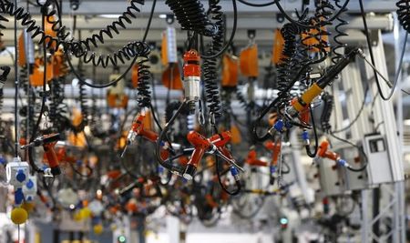 © Reuters. Various tools are seen hanging from the ceiling at the engine manufacturing unit for the new Mercedes AMG GT super sports cars at the Mercedes AMG headquarters in Affalterbach