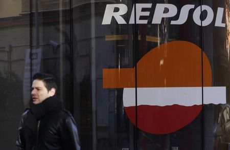 © Reuters. Прохожий у АЗС Repsol в Мадриде