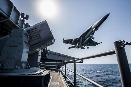 © Reuters. A U.S. Navy F/A-18 launches from the USS Carl Vinson in this undated handout picture