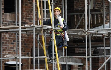 © Reuters. A builder works at a Bovis homes housing development near Bolton