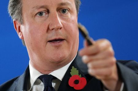 © Reuters. Britain's Prime Minister David Cameron points at reporters as he attends a news conference after an EU summit in Brussels