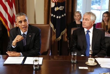 © Reuters. U.S. President Obama speaks as Secretary of Defense Hagel listens before the start of a Cabinet Meeting in the Cabinet Room at the White House in Washington