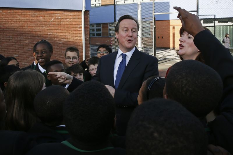 © Reuters. Britain's Prime Minister Cameron speaks with year seven students at the Harris City Academy in south London