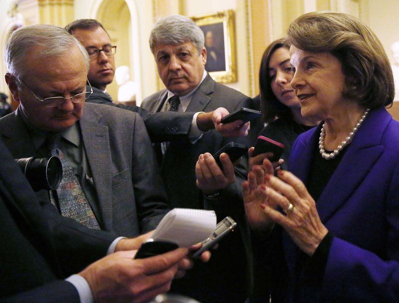 © Reuters. Senate Intelligence Committee chair Senator Dianne Feinstein (D-CA) (R) talks to reporters after coming out of the Senate in Washington