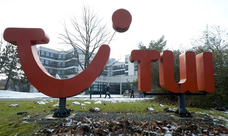 © Reuters. People pass the logo of German travel company TUI AG at the company's headquarters in Hanover