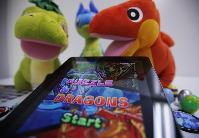 © Reuters. An iPad showing GungHo Online Entertainment Inc's mobile online game Puzzle and Dragons is displayed with the game's merchandise at the company's offices in Tokyo
