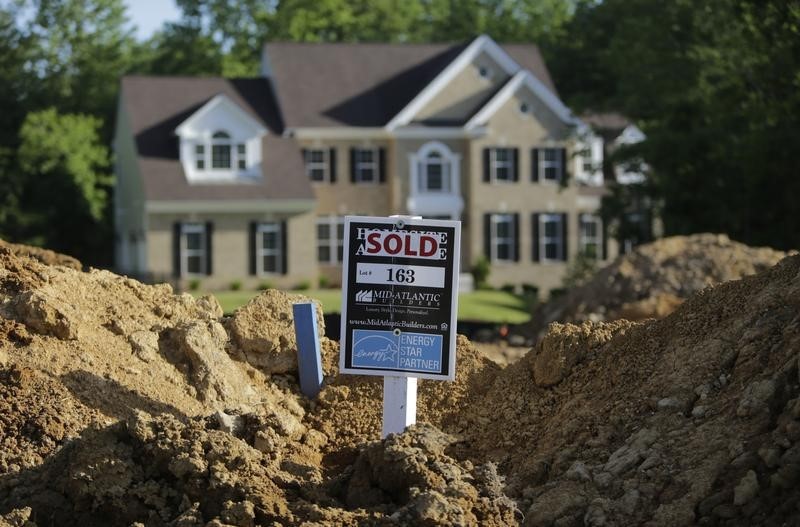 © Reuters. A completed house is seen behind the earthworks of a home currently under construction in Brandywine