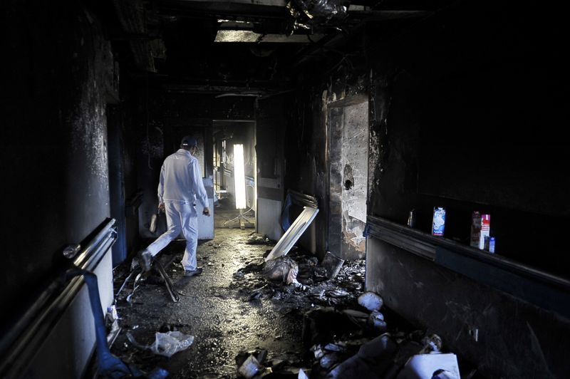 © Reuters. A hospital staff inspects the damage at the Benghazi Medical Center after a shell hit the sixth floor causing a fire in part of the building, according to the security office at the hospital, in Benghazi