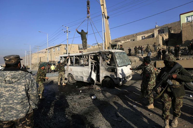 © Reuters. Afghan National Army soldiers inspect the site of a suicide attack in Kabul