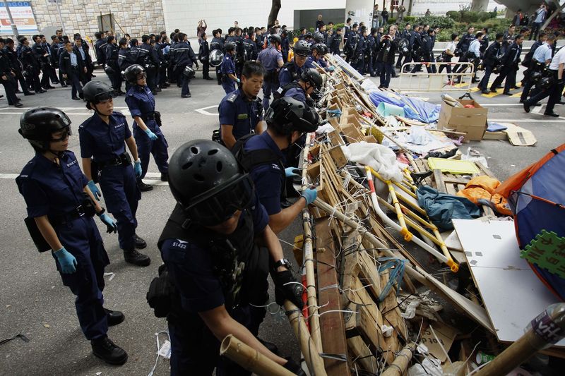© Reuters. المحتجون في هونج كونج يرددون "سنعود" مع تفكيك موقع الاعتصام