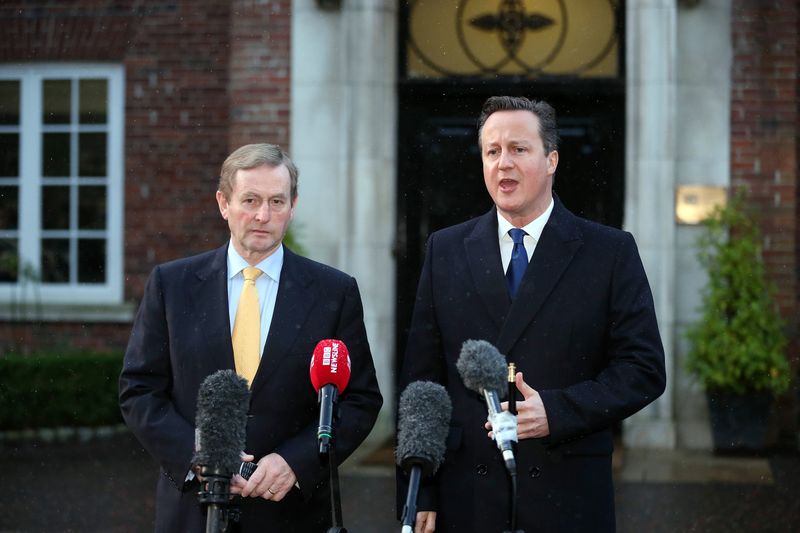 © Reuters. Ireland's Taoiseach Enda Kenny and Britain's Prime Minister David Cameron speak to the press after leaving talks with Northern Ireland's political parties at Stormont House in Belfast